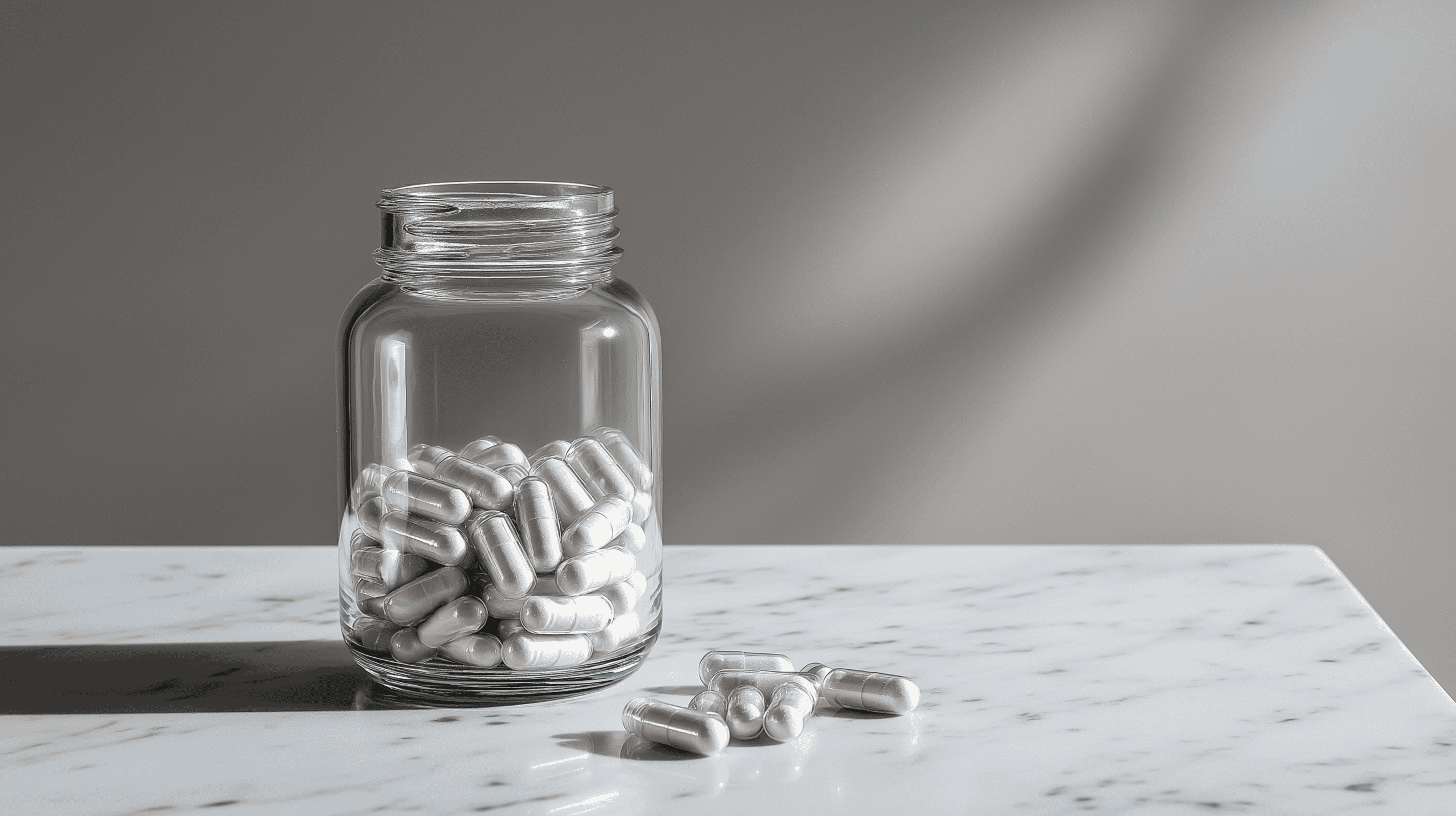 Unmarked supplement capsules in glass jar on white marble, turkesterone research review